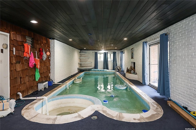 view of swimming pool featuring an indoor hot tub