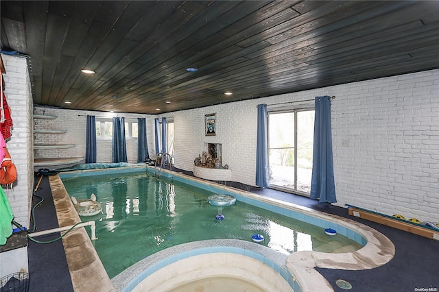 view of swimming pool featuring an indoor hot tub