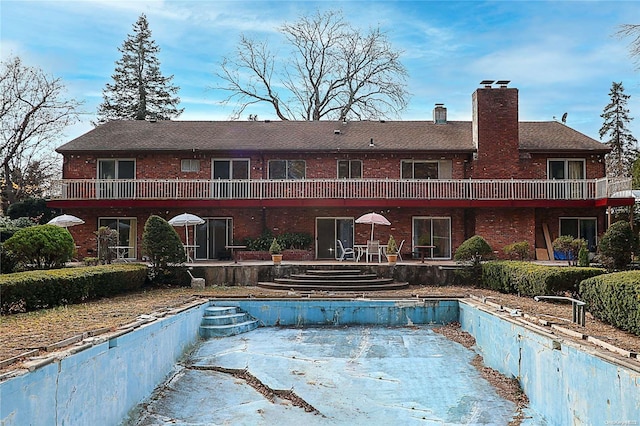 20 Rolling Hill Rd, Old Westbury, NY 11568 - back of house with brick siding, a chimney, and a patio