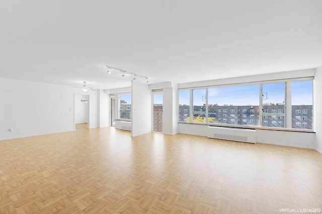 166-25 Powells Cove Blvd Unit 8D, Beechhurst, NY 11357 - empty room featuring radiator, ceiling fan, and baseboards
