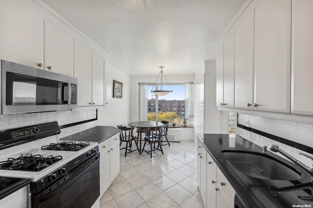 166-25 Powells Cove Blvd Unit 8D, Beechhurst, NY 11357 - kitchen with range with gas stovetop, stainless steel microwave, decorative backsplash, light tile patterned flooring, and a sink
