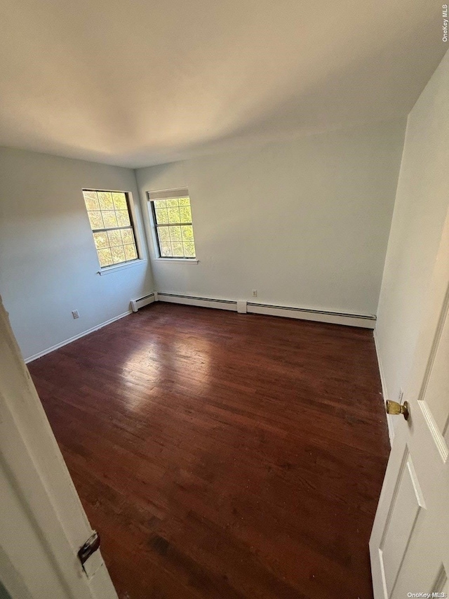 spare room with dark hardwood / wood-style flooring