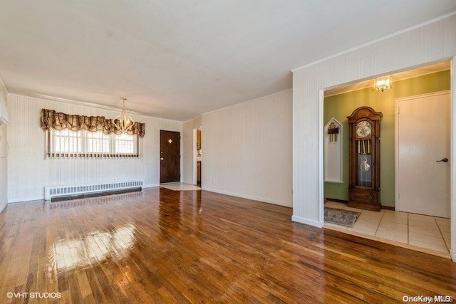 interior space featuring hardwood / wood-style floors, radiator heating unit, and an inviting chandelier