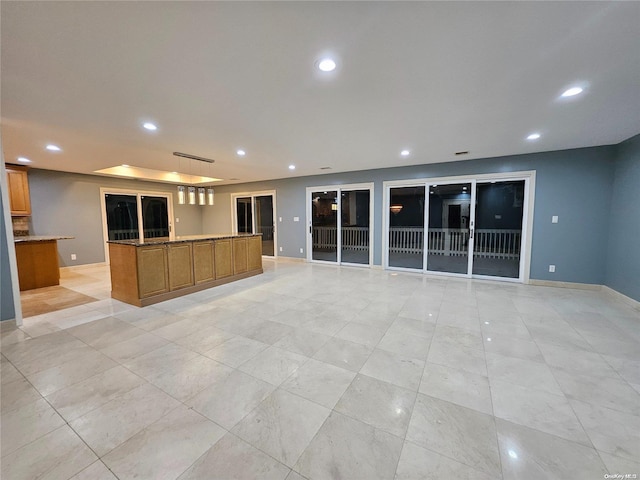 unfurnished living room featuring recessed lighting, baseboards, and light tile patterned flooring