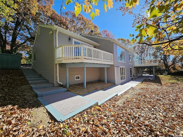 back of house featuring a deck and stairway