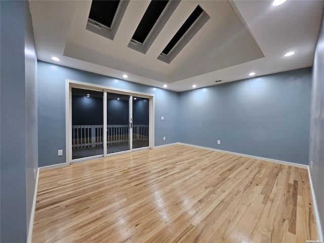 unfurnished room with recessed lighting, light wood-type flooring, and baseboards