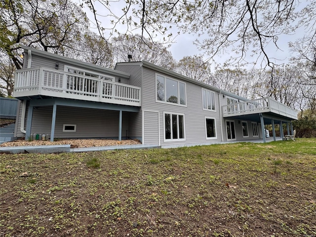rear view of property featuring a deck