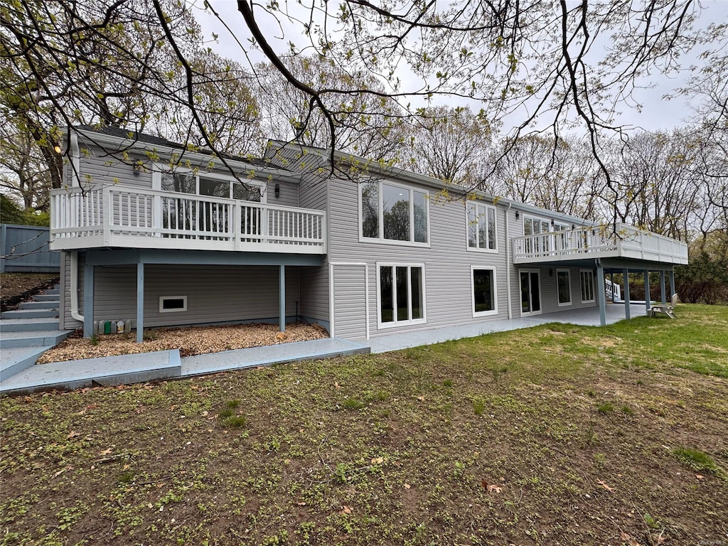 21 Lodge Ln, Port Jefferson, NY 11777 - rear view of property with a lawn, a wooden deck, stairway, and a patio