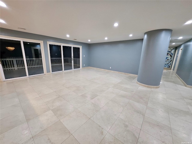 spare room featuring baseboards and recessed lighting