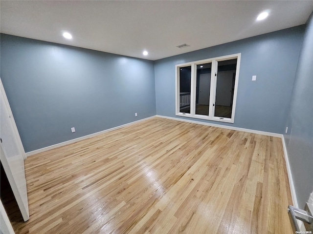 empty room with recessed lighting, baseboards, visible vents, and light wood finished floors