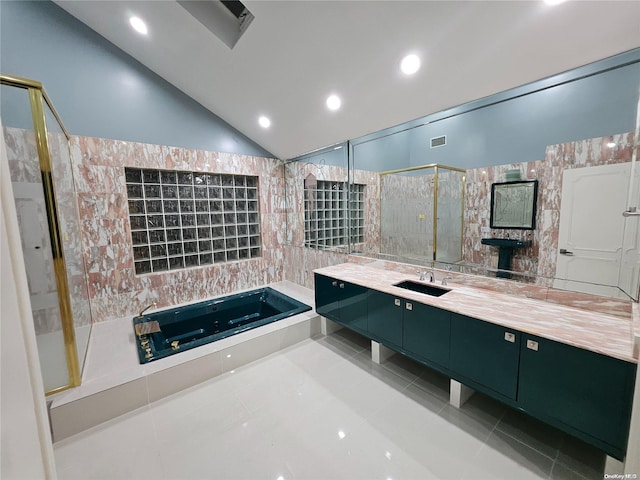 bathroom with a garden tub, tile patterned flooring, a shower stall, vanity, and lofted ceiling