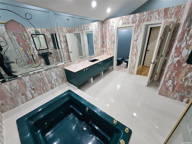 full bathroom featuring visible vents, vaulted ceiling, vanity, a whirlpool tub, and toilet