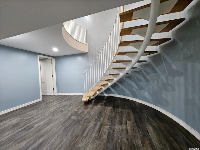 stairway with baseboards, recessed lighting, and wood finished floors