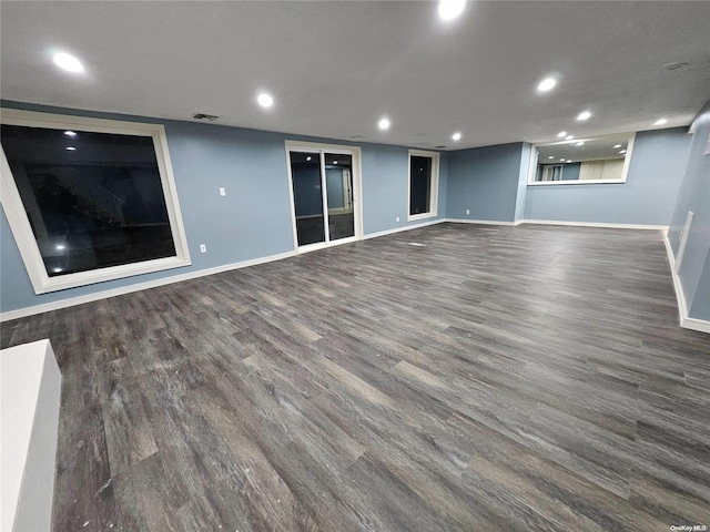 empty room featuring baseboards, recessed lighting, and wood finished floors