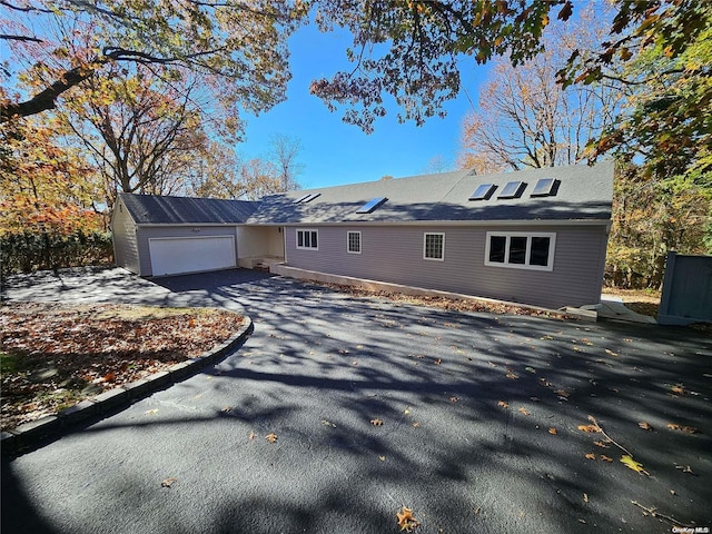 ranch-style home featuring an attached garage and driveway