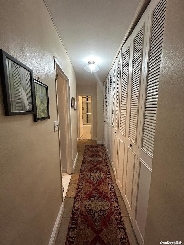 corridor with light tile patterned floors