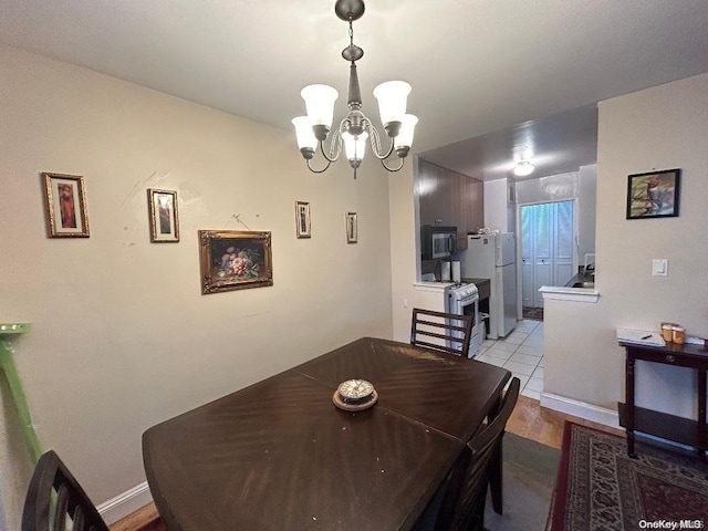 dining room featuring light hardwood / wood-style floors and a notable chandelier