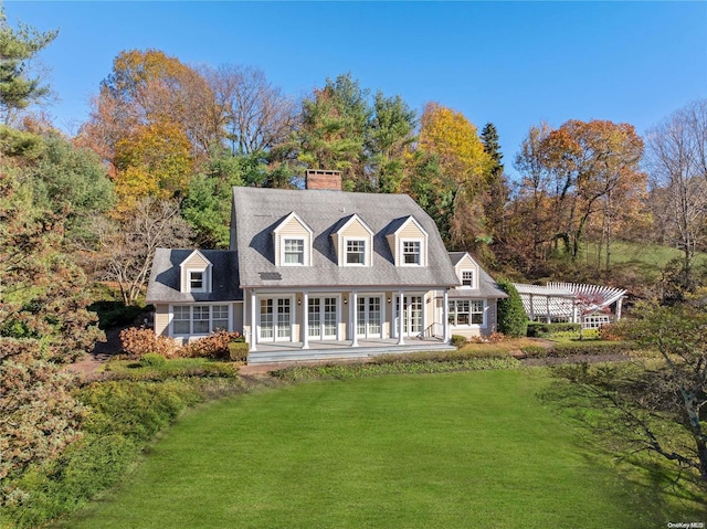 rear view of property with a yard