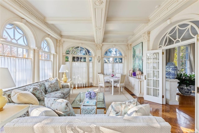 sunroom featuring beamed ceiling and a wealth of natural light