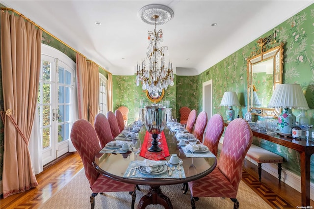 dining space with light parquet floors, an inviting chandelier, a wealth of natural light, and french doors
