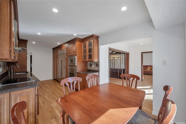 dining room with light hardwood / wood-style flooring and sink