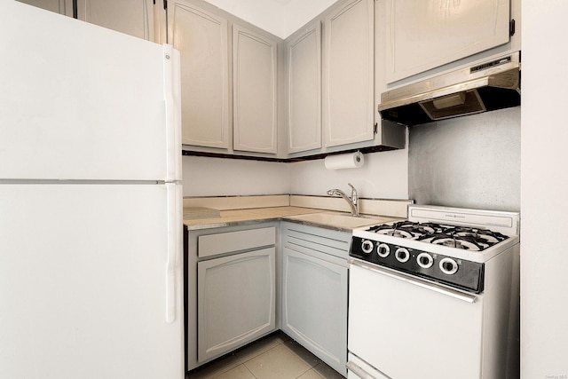 kitchen featuring white appliances, gray cabinets, sink, and light tile patterned floors