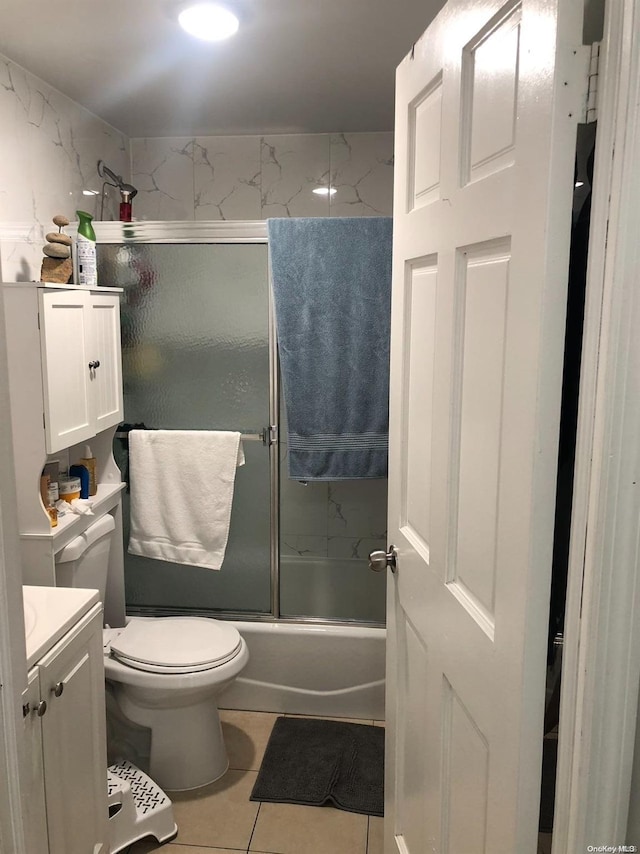 full bathroom with tile patterned floors, vanity, toilet, and enclosed tub / shower combo