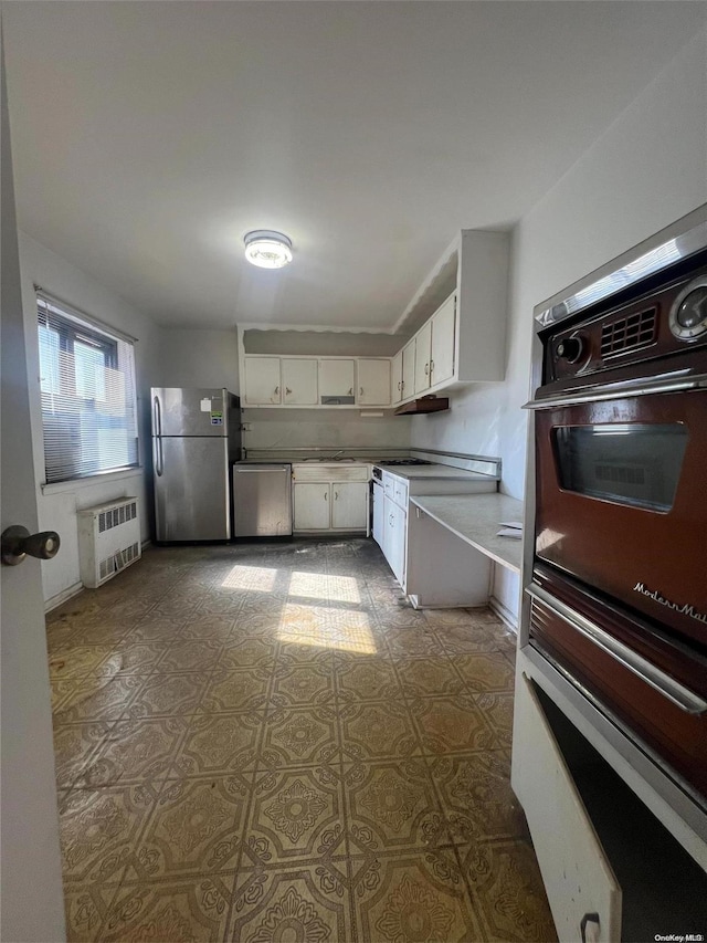 138-25 31st Dr Unit 3E, Flushing, NY 11354 - kitchen with appliances with stainless steel finishes, radiator heating unit, and white cabinets