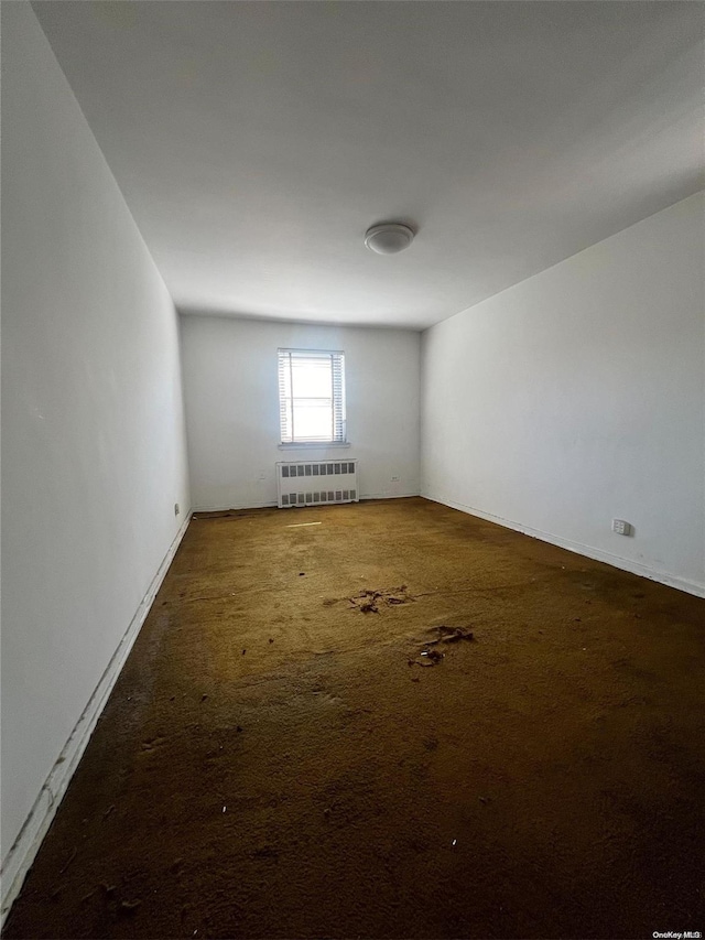 138-25 31st Dr Unit 3E, Flushing, NY 11354 - carpeted empty room with radiator heating unit and baseboards