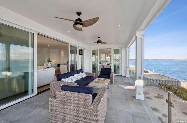 view of patio featuring ceiling fan, a water view, and outdoor lounge area