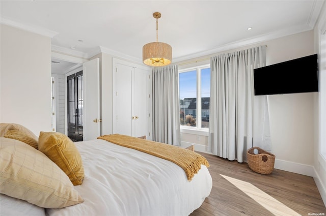 bedroom featuring hardwood / wood-style flooring and crown molding