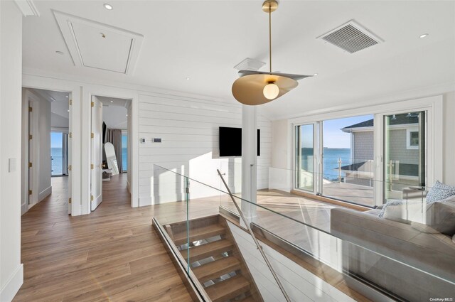 interior space featuring hardwood / wood-style flooring and wooden walls