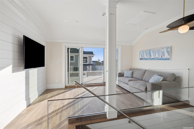 living room with light hardwood / wood-style floors, decorative columns, ceiling fan, lofted ceiling, and crown molding