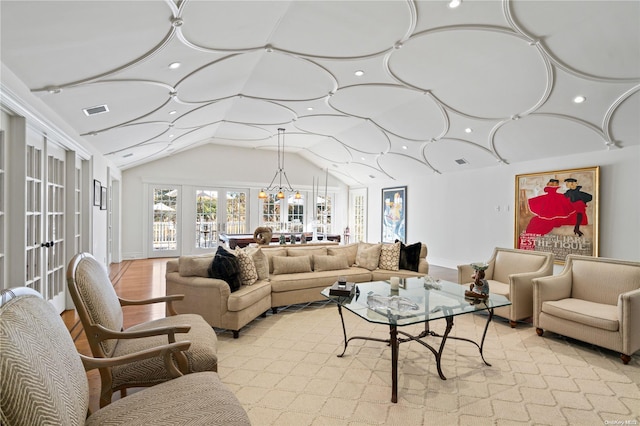 living room with vaulted ceiling and french doors