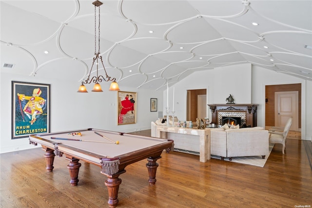 recreation room with a tile fireplace, pool table, lofted ceiling, and hardwood / wood-style flooring