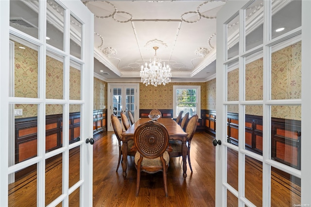 dining space featuring a tray ceiling, french doors, hardwood / wood-style floors, and ornamental molding