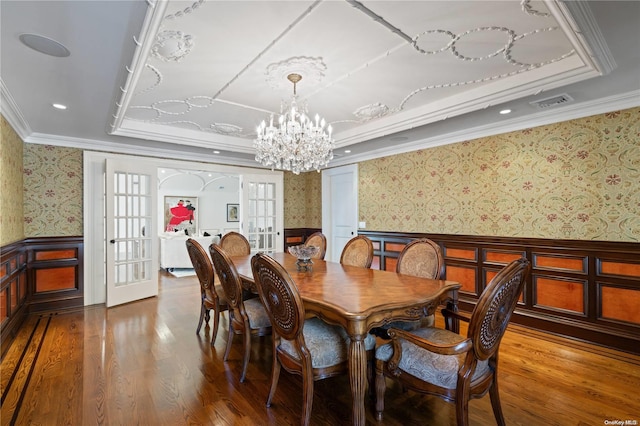 dining room featuring french doors, hardwood / wood-style flooring, crown molding, and a tray ceiling