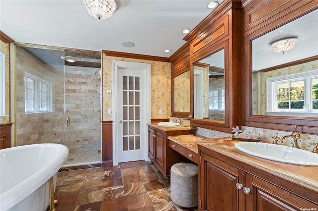 bathroom with vanity, crown molding, and plus walk in shower