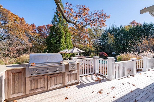 wooden deck with a grill and an outdoor kitchen