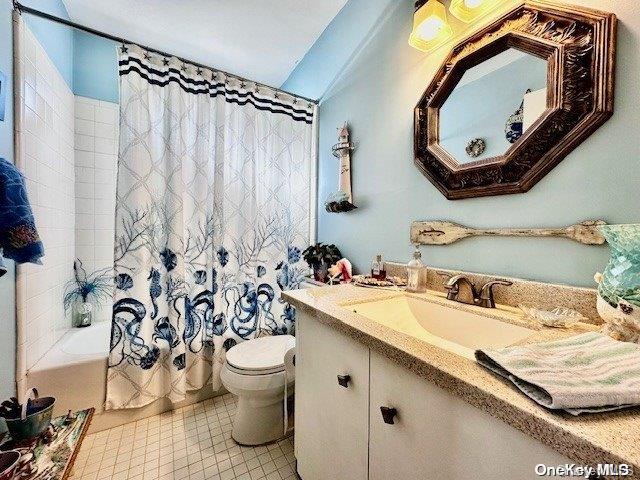 full bathroom with vanity, toilet, and shower / bath combo with shower curtain