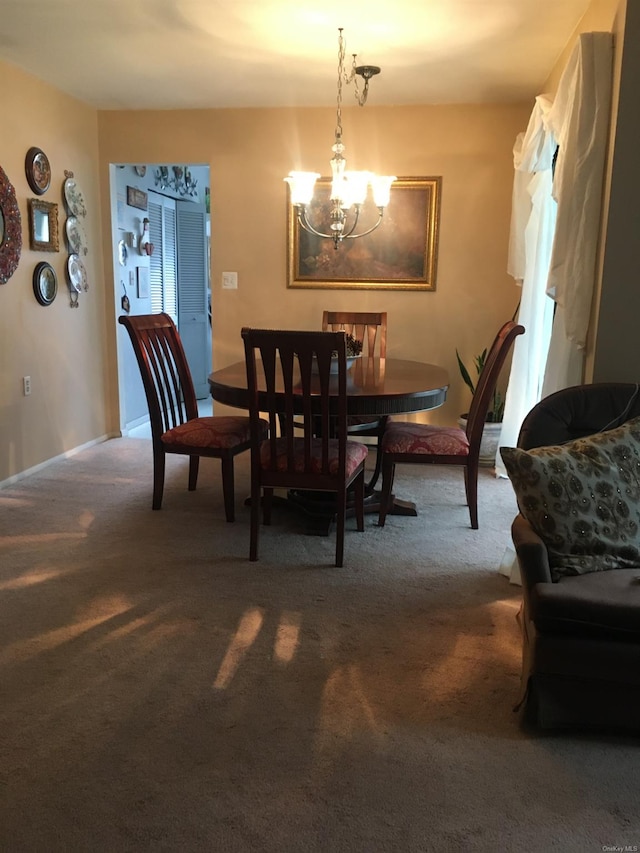 carpeted dining space featuring a chandelier