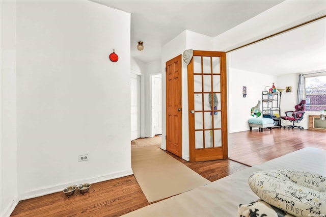 bedroom featuring french doors and light wood-type flooring