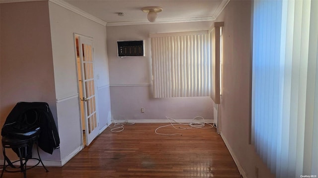 empty room with dark hardwood / wood-style flooring, crown molding, and french doors