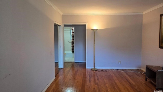 spare room with crown molding and hardwood / wood-style flooring