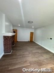 bonus room with dark wood-type flooring