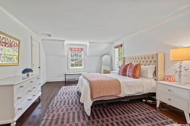 bedroom featuring dark hardwood / wood-style floors, vaulted ceiling, and crown molding