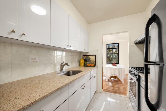 kitchen featuring white cabinets, appliances with stainless steel finishes, light hardwood / wood-style floors, and sink