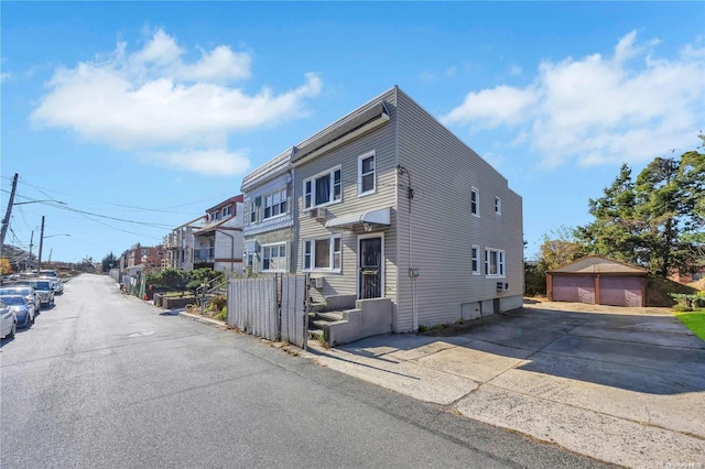 view of front of property featuring an outbuilding and a garage