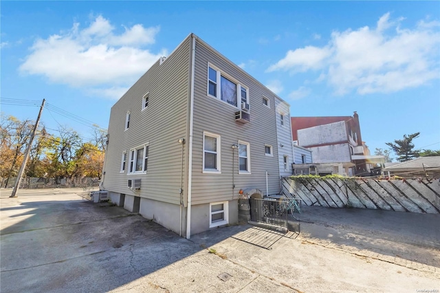 back of house with cooling unit and a wall unit AC