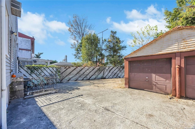 view of patio with a garage and an outdoor structure